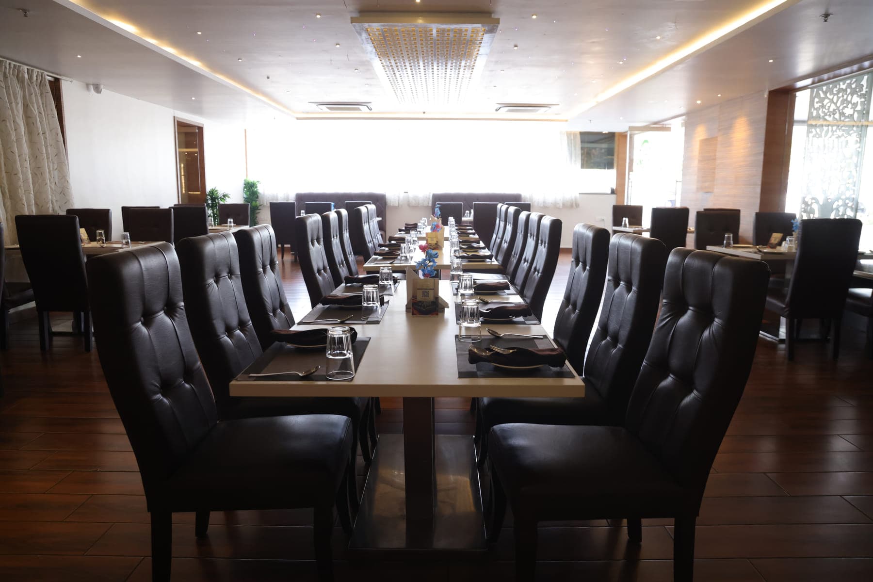 The banquet room set with a single long table for a gathering