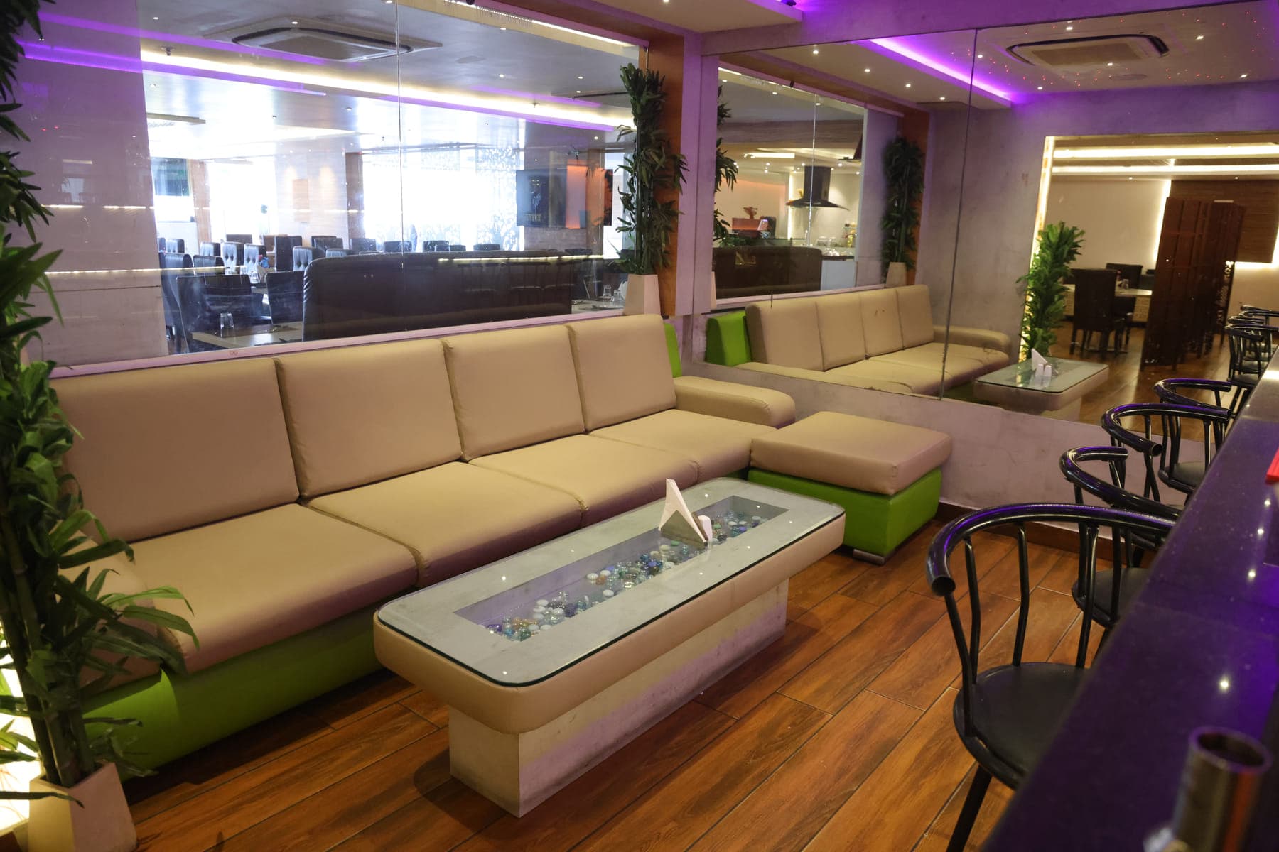 Low lounge seating beside the restaurant, with a long upholstered banquette