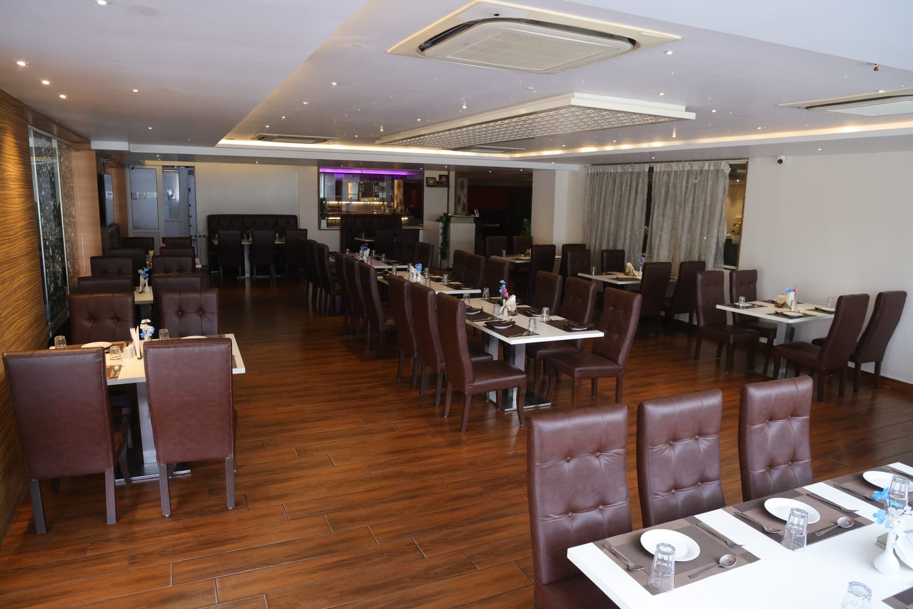 The main dining hall, with tables set across a wooden floor