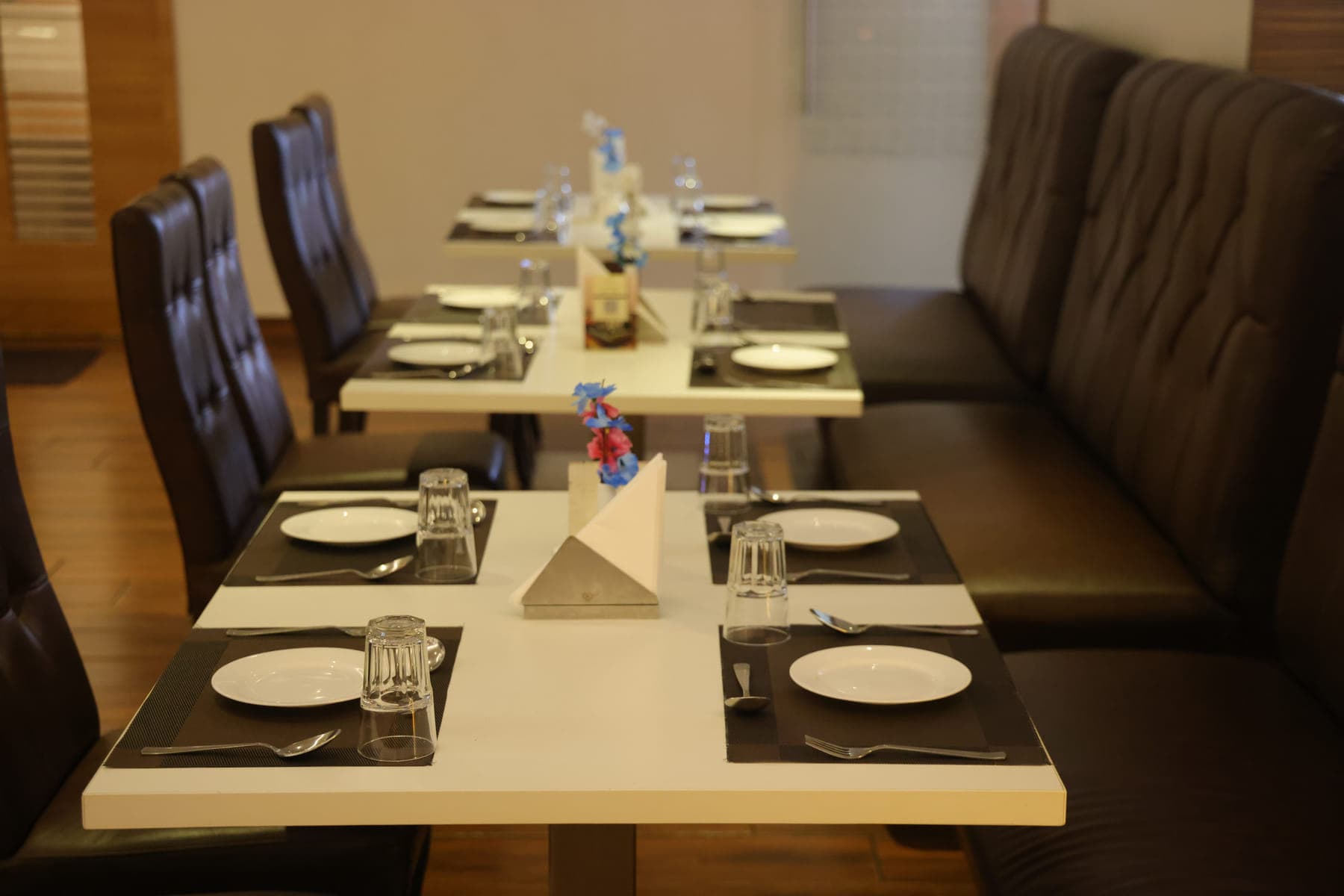 A table set for four, with folded napkins and glassware